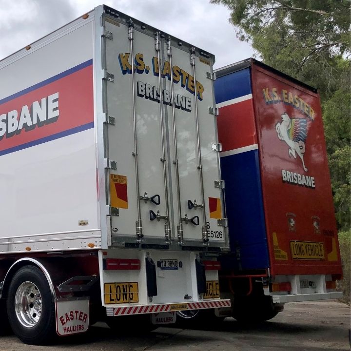 Backend of a white 26 pallet FTE trailer on Alcoa wheels with red signage saying Ron Finemore Transport