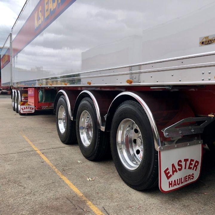 Backend of a white KS Easter B-Double trailer on Alcoa Dura-Bright wheels