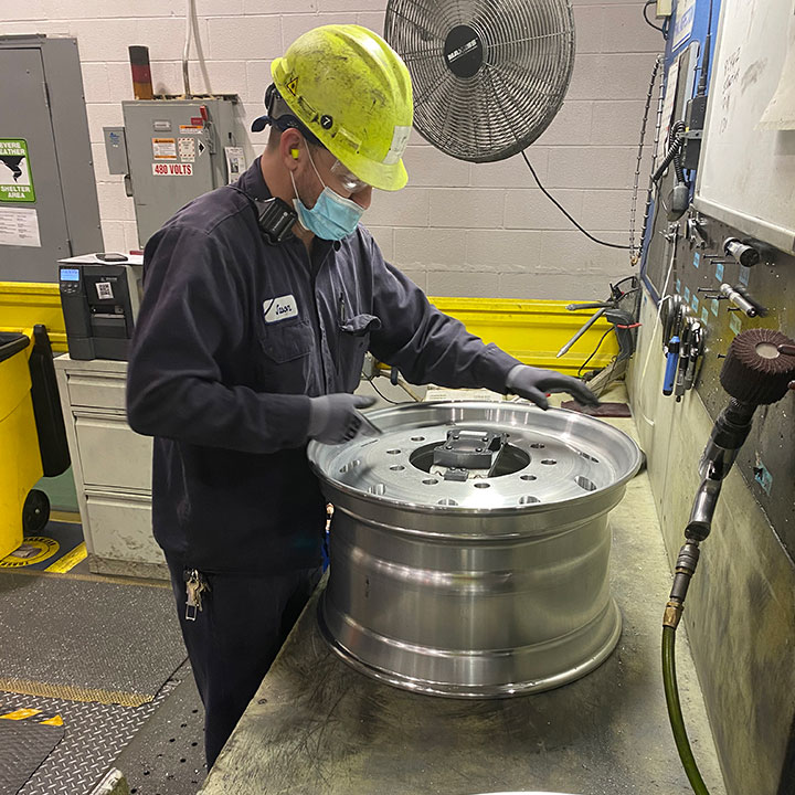 Engineer with an Alcoa Wheel checking quality and performance criteria