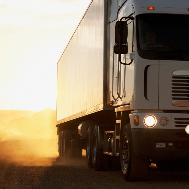 White semi-trailer on Alcoa® Ultra ONE® Wheels face on at sunrise