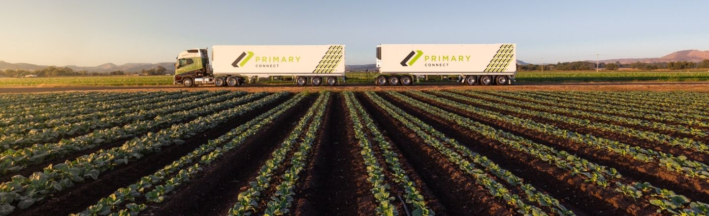 FTE equipment on Alcoa Wheels on a road near a cabbage field