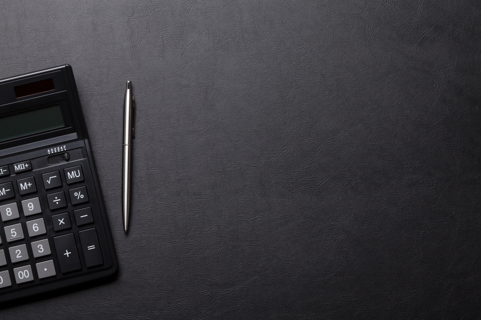 Office leather desk table with calculator, pen